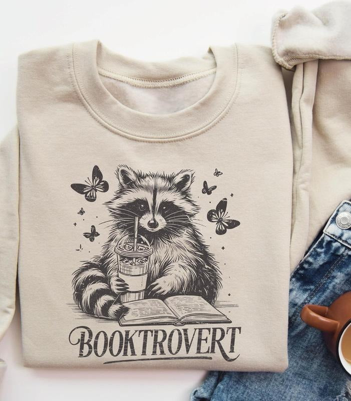 Booktrovert Book Lover Reading Raccoon Funny Bookish - Adult & Kids T-Shirts, Sweatshirts & Hoodies apparel design preview 1