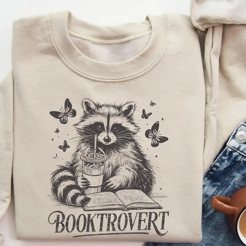 Booktrovert Book Lover Reading Raccoon Funny Bookish - Adult & Kids T-Shirts, Sweatshirts & Hoodies apparel design preview 1