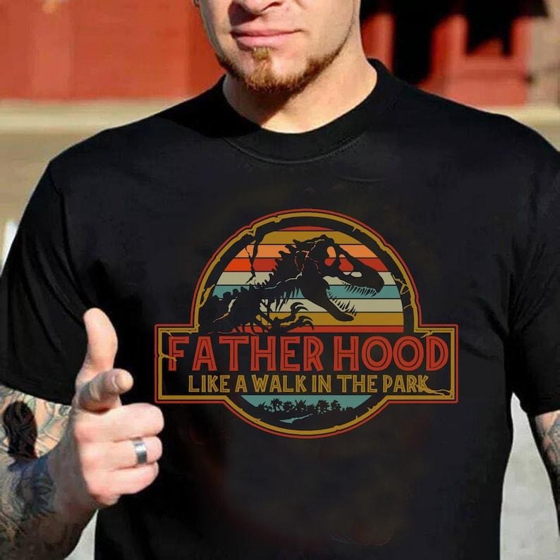 Fatherhood Is Walk Park New Dad Dinosaur Party Life - Adult & Kids T-Shirts, Sweatshirts & Hoodies apparel design preview 1
