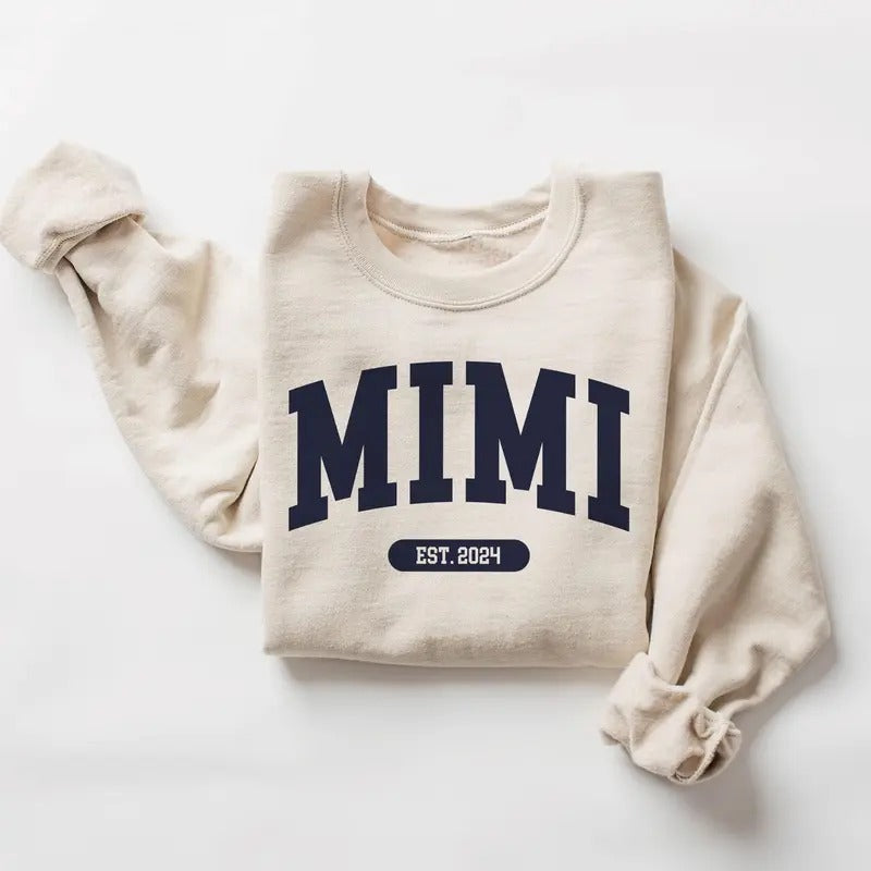 Mimi Varsity Xmas EST 2024 New Be Pregnancy Reveal - Adult & Kids T-Shirts, Sweatshirts & Hoodies apparel design preview 1